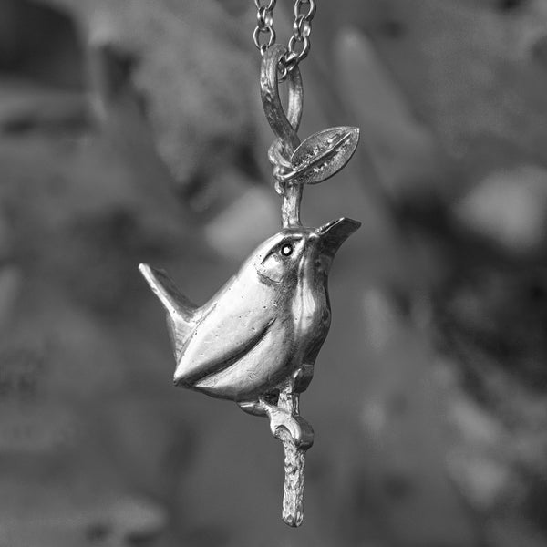 Wren resting on twig pendant