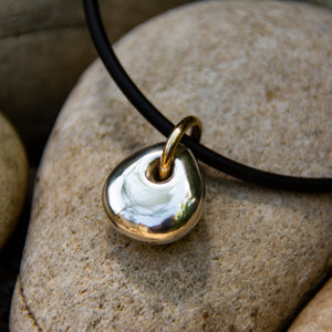 Solid silver pebble style pendant with gold bail