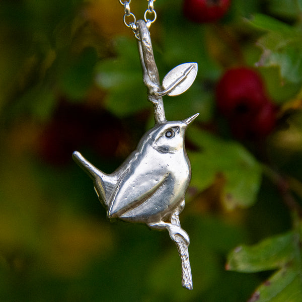 Wren resting on twig pendant