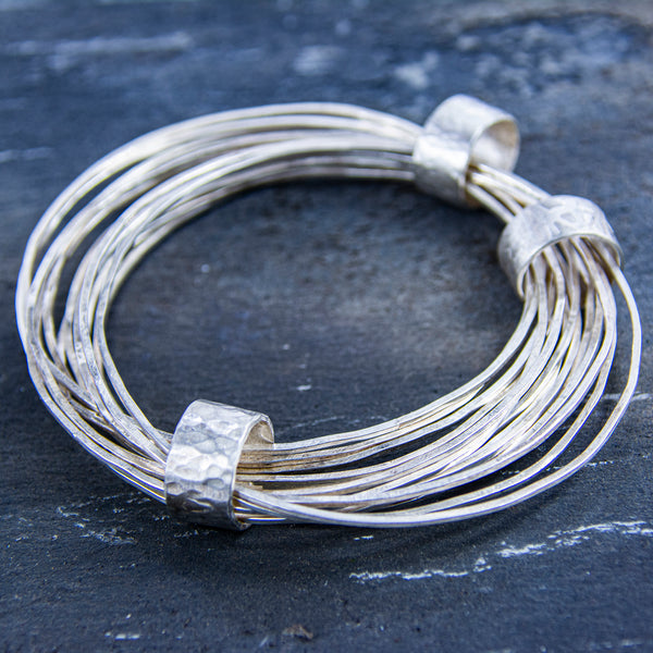 Sterling silver bangles captured by three sterling silver rings
